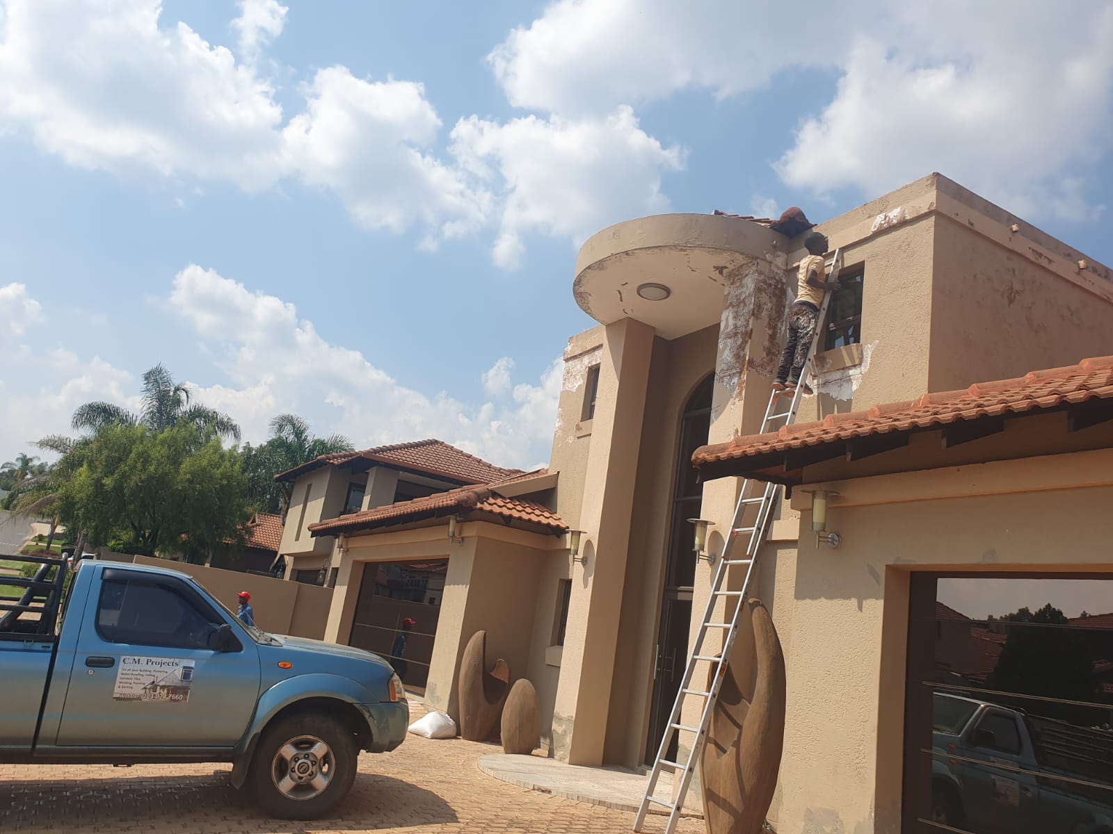 C.M Construction team painting and waterproofing a double storey home in Hartbeespoort