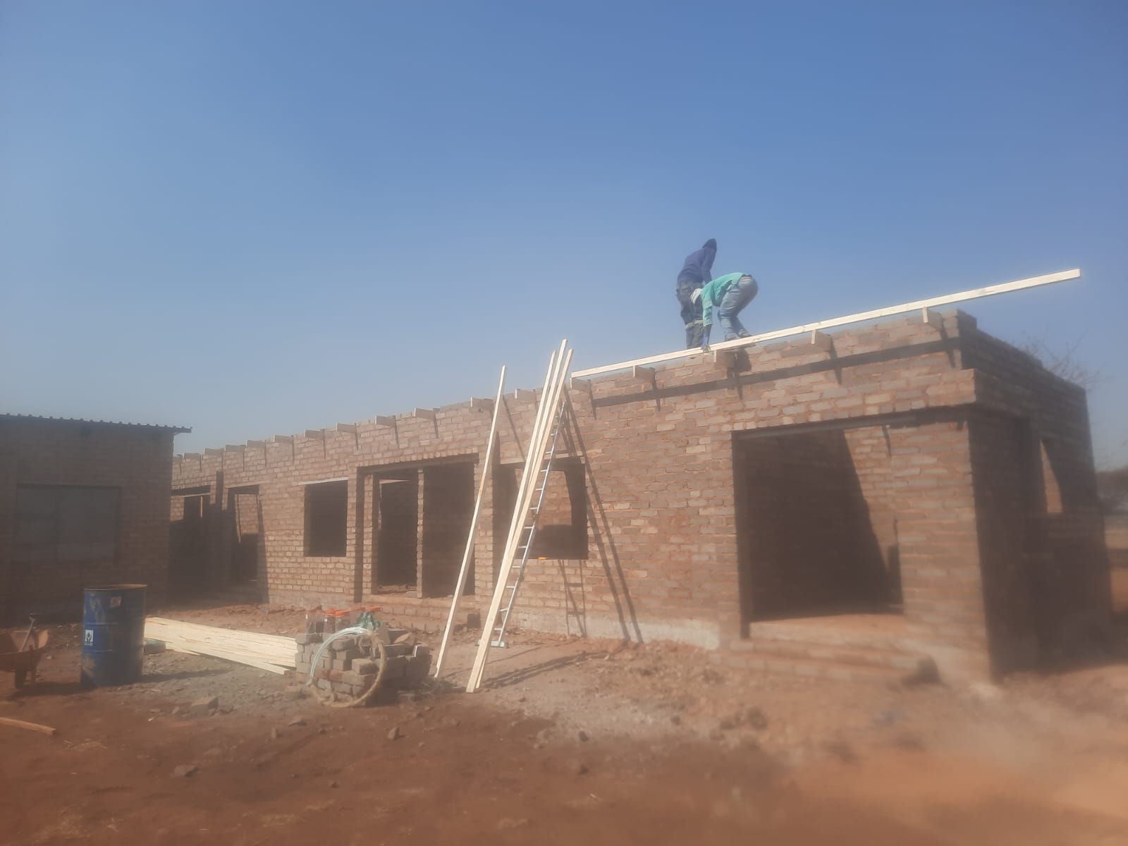 New house brickwork construction with roof timbers going up in Brits