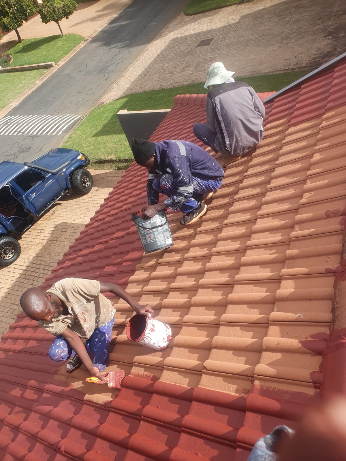 C.M Construction team repairing and painting a tiled roof in Pretoria